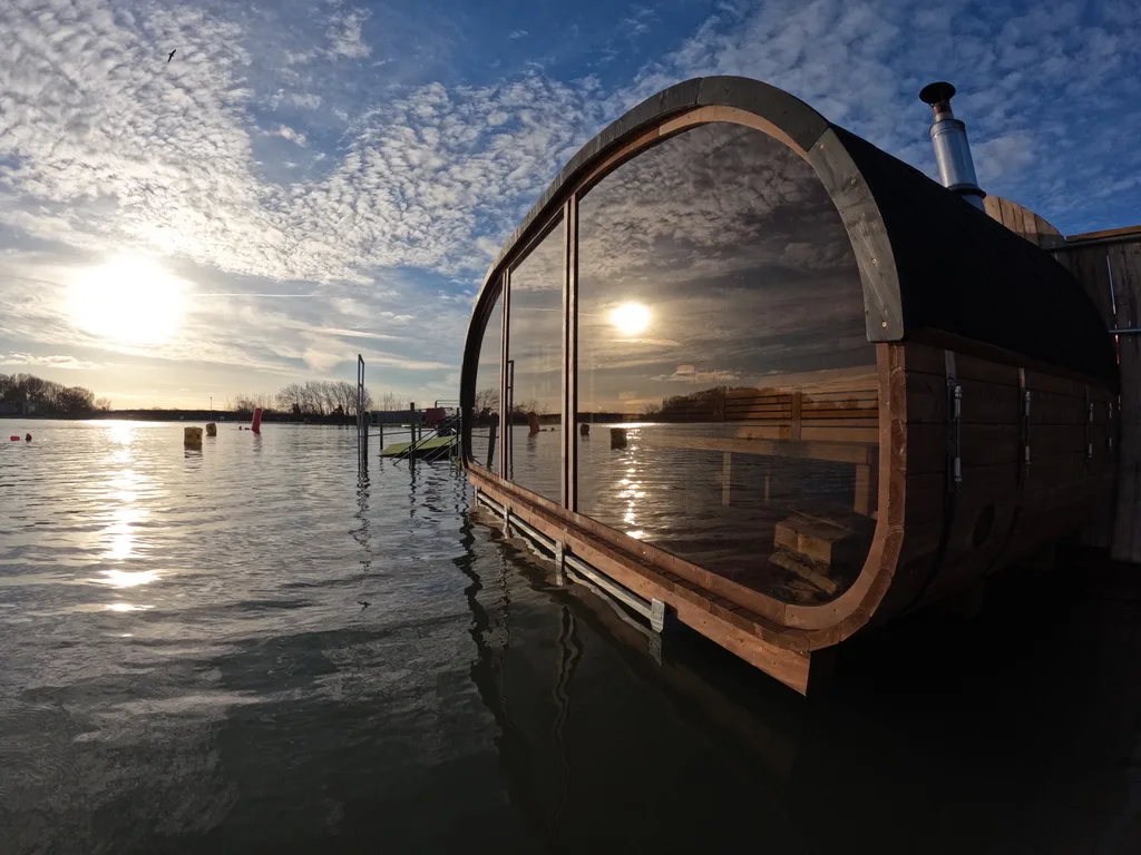 Interior view of the floating sauna at West Country Water Park showing hot stone bench and wooden cabin