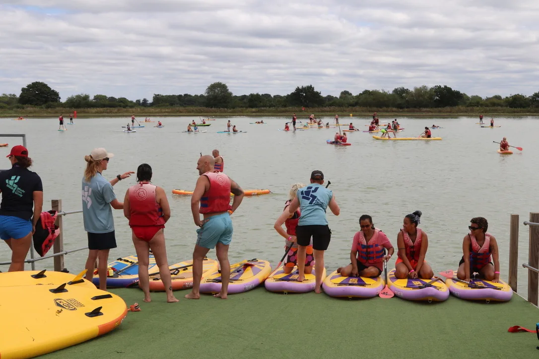 Stand up paddleboarding on the natural lake at West Country Water Park, a paddle sports centre near Bristol