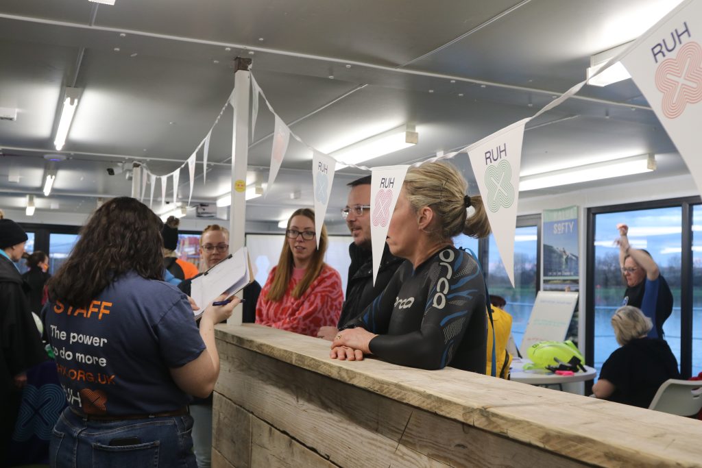 charity gathering inside the cafe shows people queueing and bunting with the charity information on