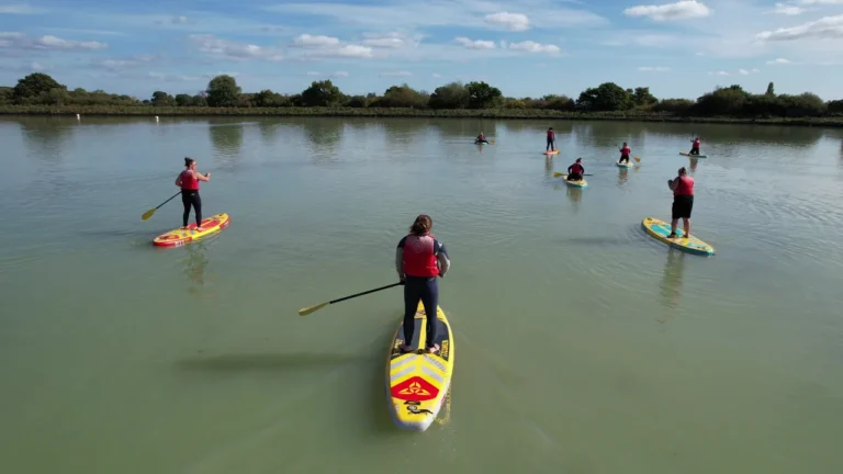 A group paddleboarding on the lake