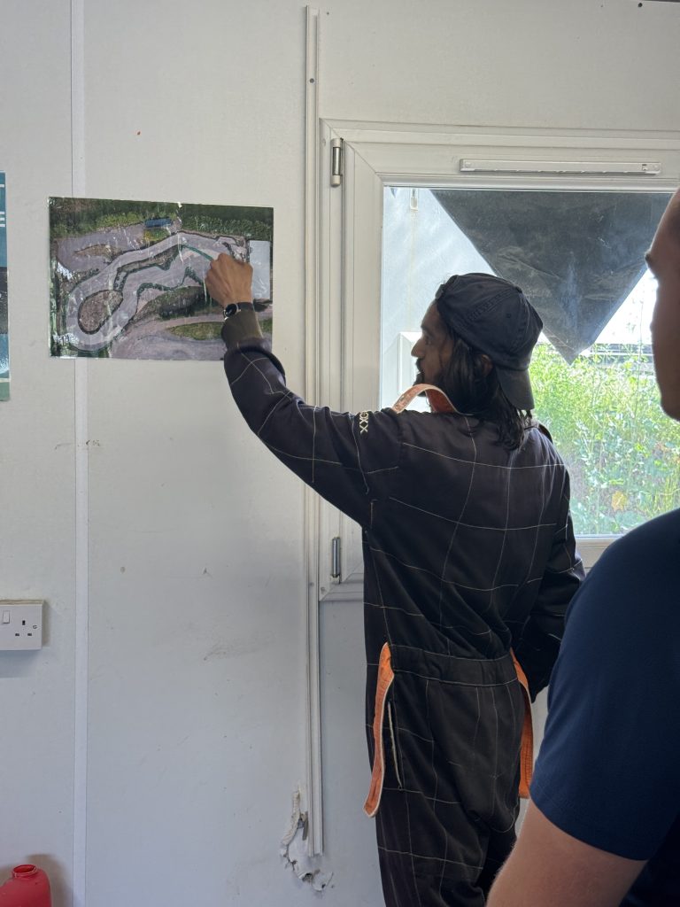karting instructor shows attendee the map of the track